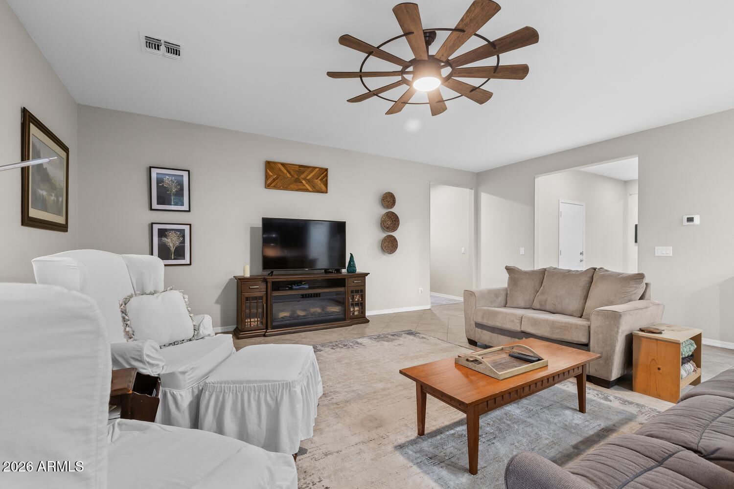 3246 North Springfield Street Buckeye, AZ 85396 - Photo 5 of 27 a living room with furniture a flat screen tv and a dining table