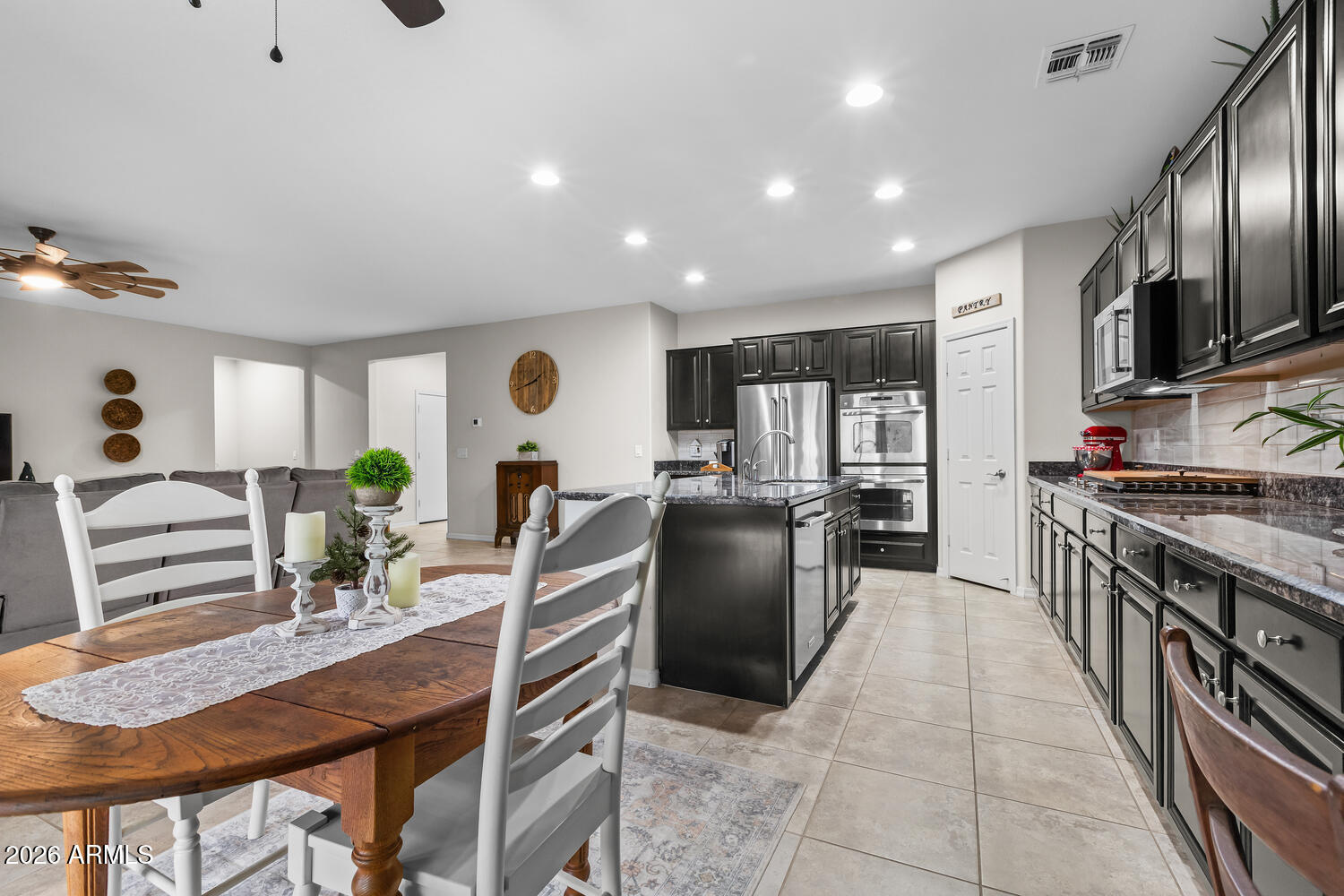 3246 North Springfield Street Buckeye, AZ 85396 - Photo 7 of 27 a kitchen with granite countertop lots of counter top space and stainless steel appliances
