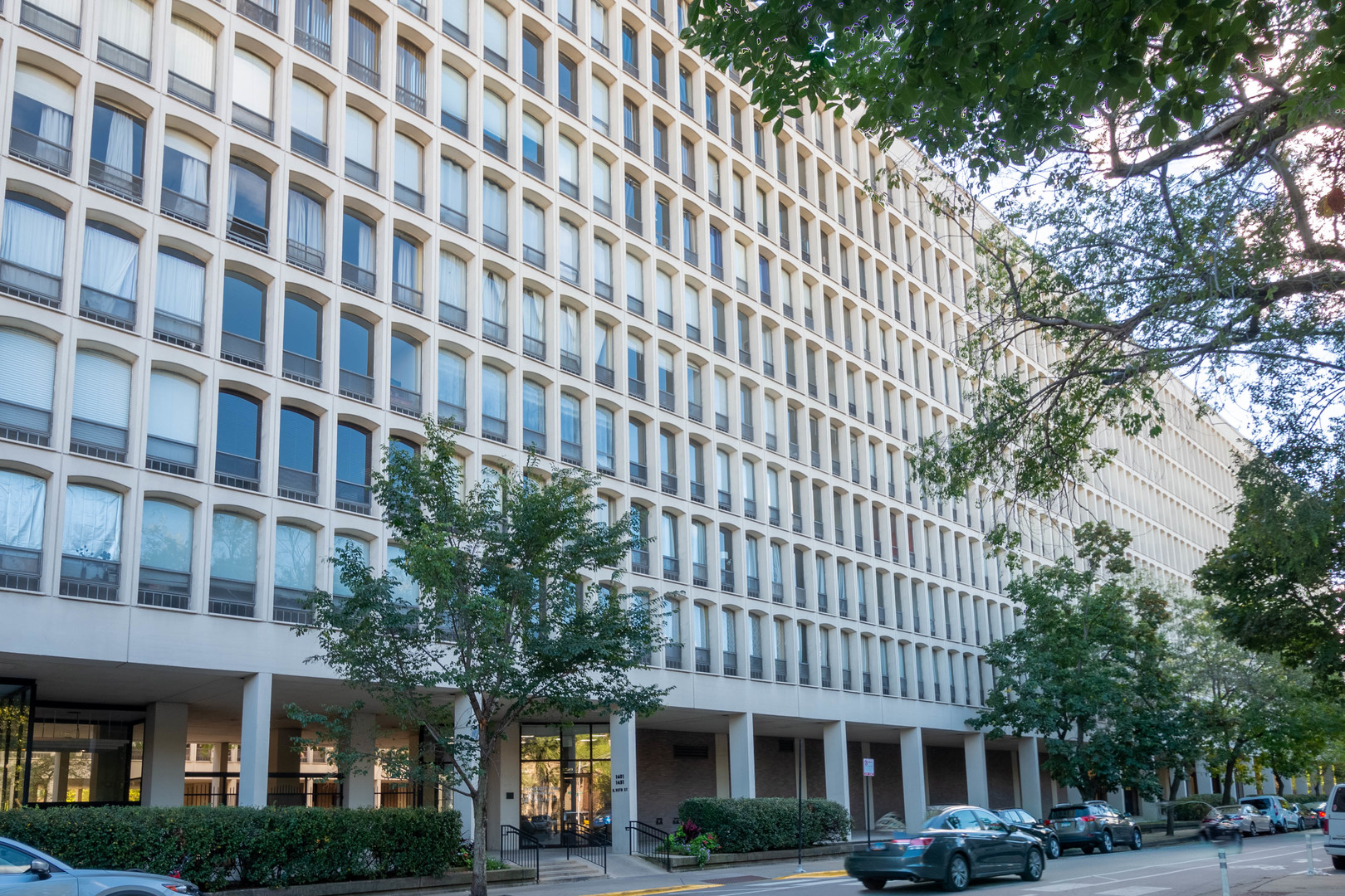 1401 East 55th Street, Unit 701N Chicago, IL 60615 - Photo 1 of 10 a front view of a building with street view