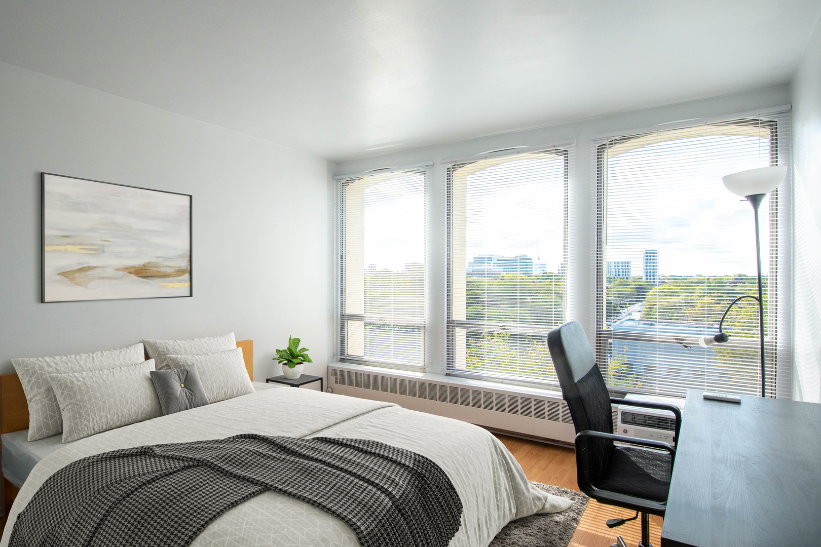 1401 East 55th Street, Unit 701N Chicago, IL 60615 - Photo 7 of 10 a bedroom with a bed and a large window with view of bedroom