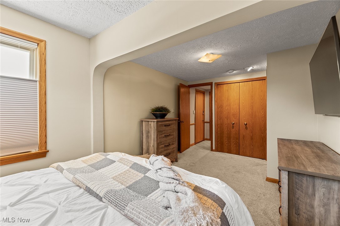 430 Stanley Road Akron, OH 44312 - Photo 14 of 36 Bedroom with a textured ceiling, carpet flooring, and a closet
