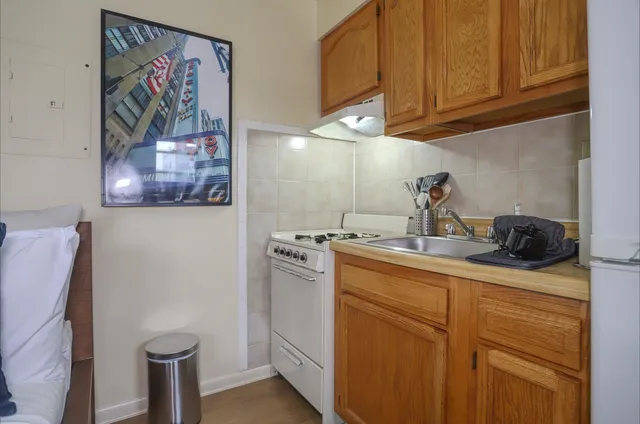 a kitchen with stainless steel appliances granite countertop a refrigerator and a stove