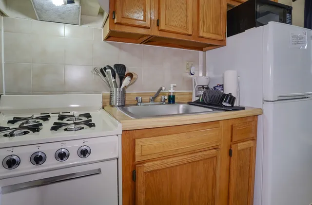 a kitchen with a stove and a refrigerator
