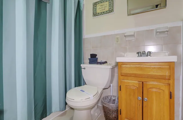 a bathroom with a sink a toilet and a mirror