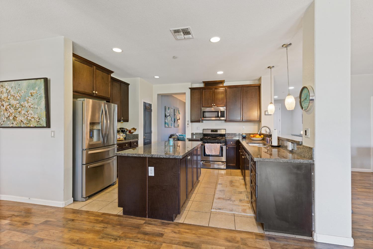 2011 Roy Ranch Way Plumas Lake, CA 95961 - Photo 39 of 49 a kitchen with stainless steel appliances granite countertop a refrigerator stove and oven