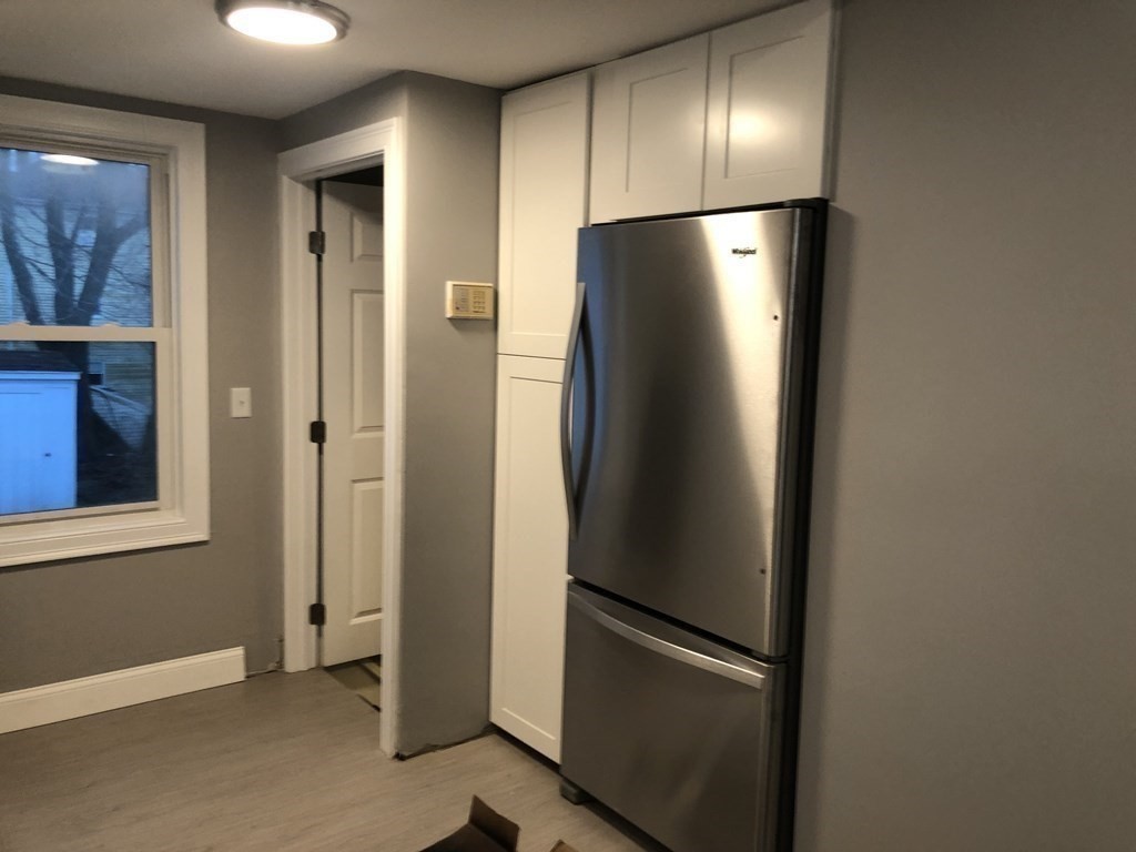 135 Winthrop Street Fall River, MA 02721 - Photo 15 of 26 a view of an empty room with wooden floor and a window