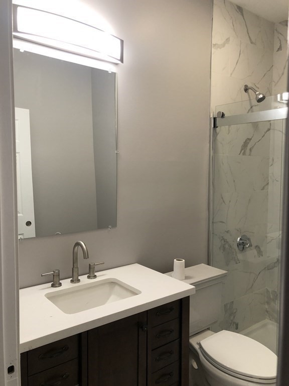 135 Winthrop Street Fall River, MA 02721 - Photo 17 of 26 a bathroom with a sink a toilet and shower