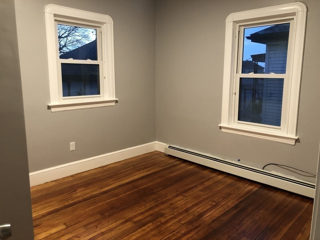 135 Winthrop Street Fall River, MA 02721 - Photo 20 of 26 a view of an empty room with wooden floor and a window
