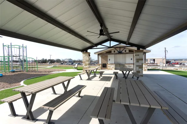 a view of a patio with table and chairs a barbeque with wooden fence