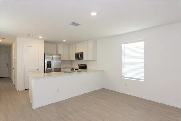 a kitchen with stainless steel appliances a refrigerator sink and cabinets