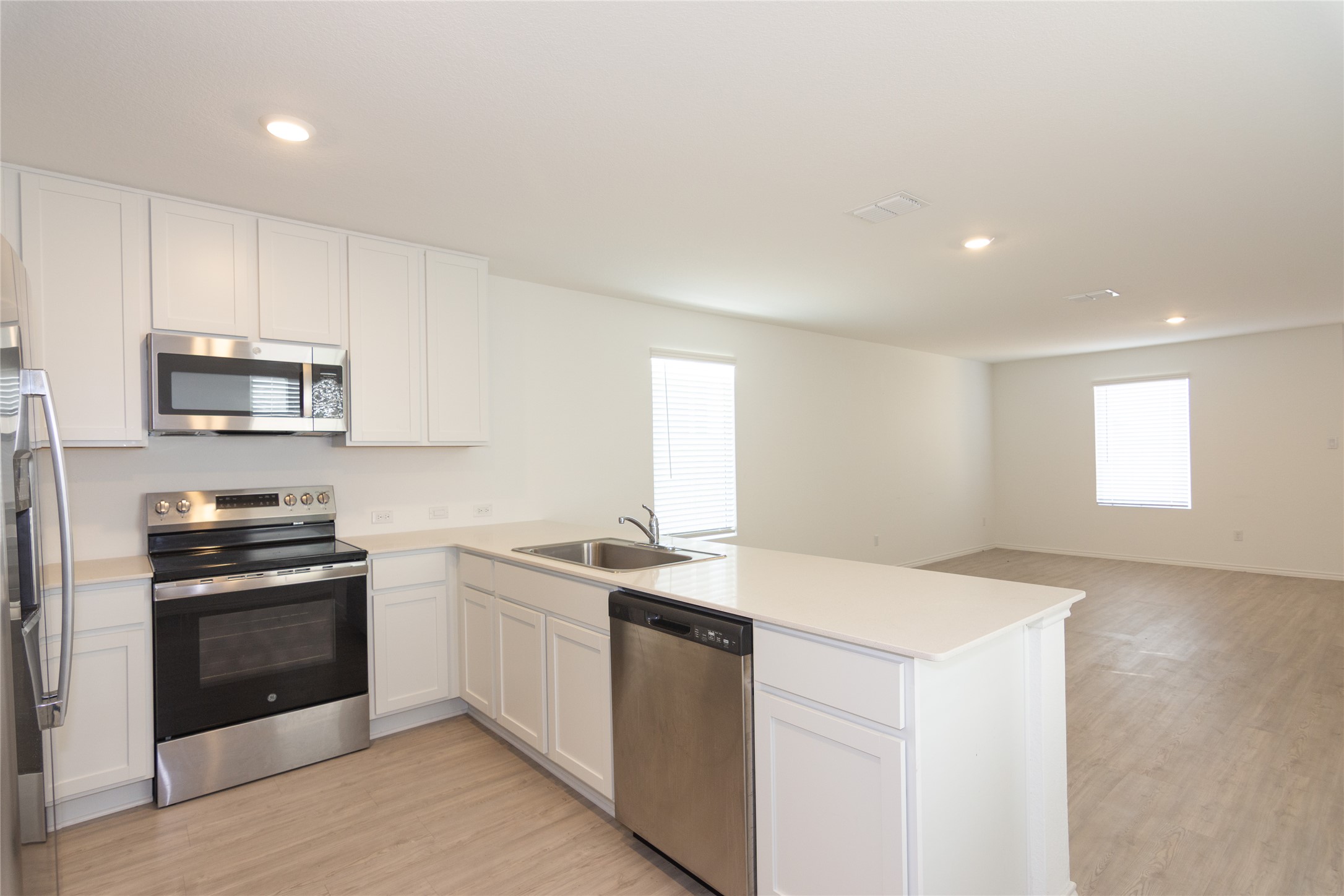 356 Marty Allen Loop Jarrell, TX 76537 - Photo 33 of 33 a kitchen with sink a microwave and cabinets