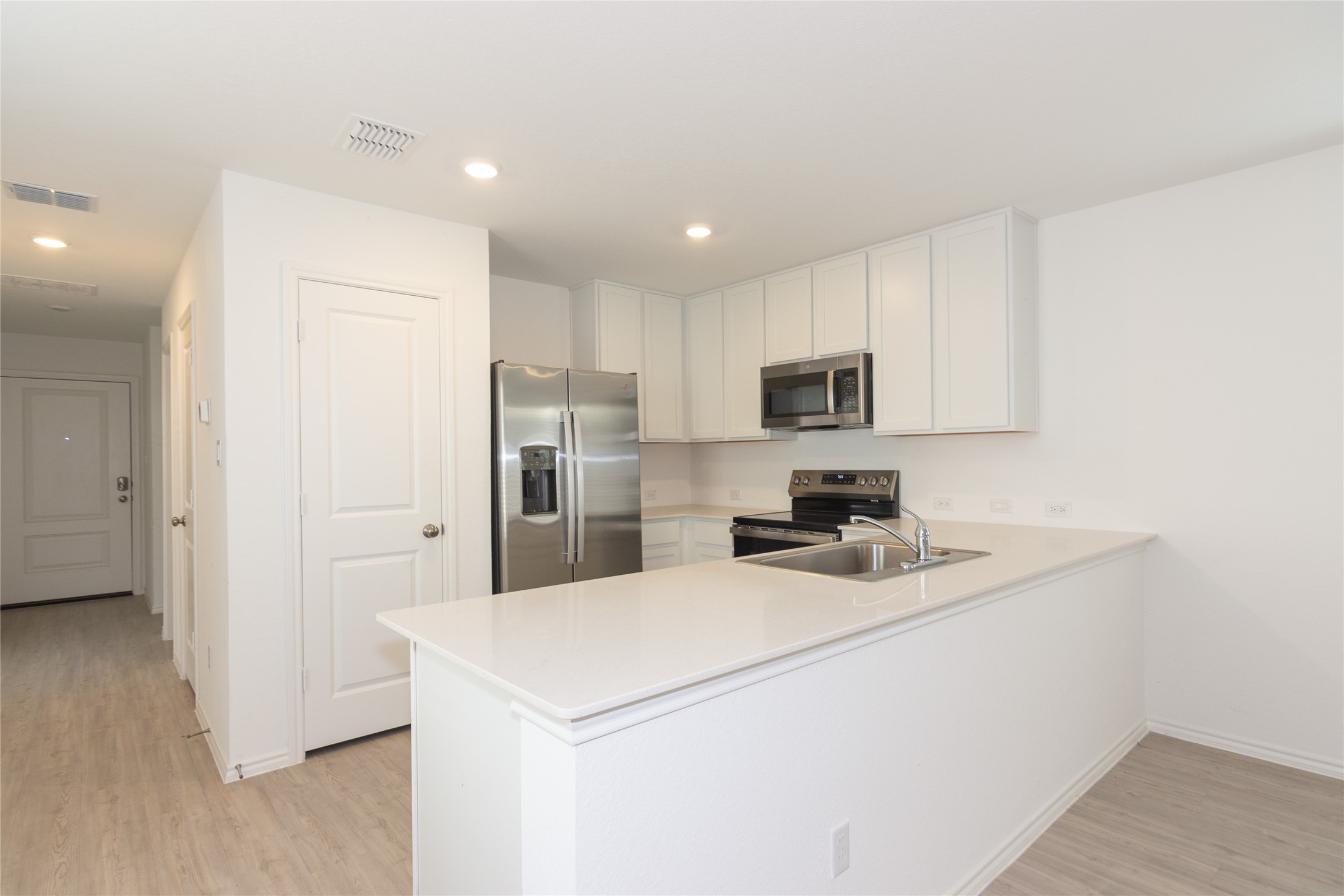 356 Marty Allen Loop Jarrell, TX 76537 - Photo 8 of 33 a kitchen with refrigerator cabinets and wooden floor