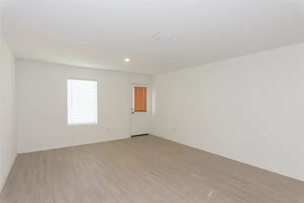 a kitchen with refrigerator cabinets and wooden floor