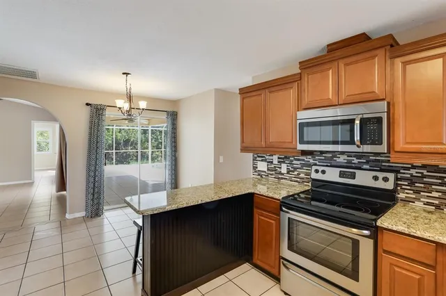 a kitchen with stainless steel appliances a stove microwave and cabinets