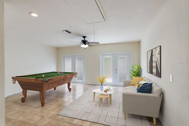 a living room with furniture and a pool table