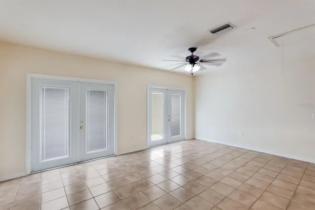 a view of an empty room with a ceiling fan