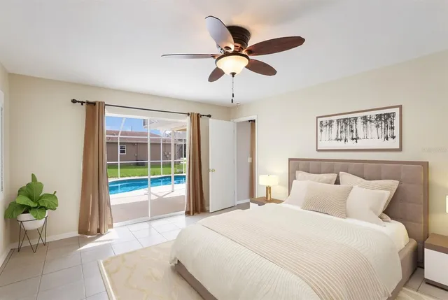 a spacious bedroom with a bed and ceiling fan