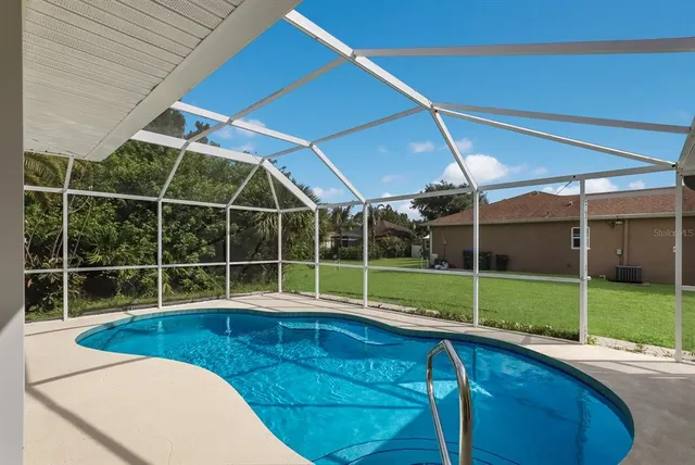 a view of a room with wooden floor and windows