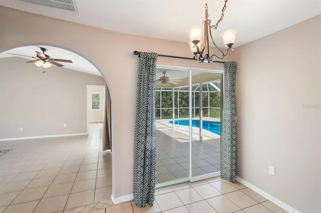 a view of a livingroom with a ceiling fan and window