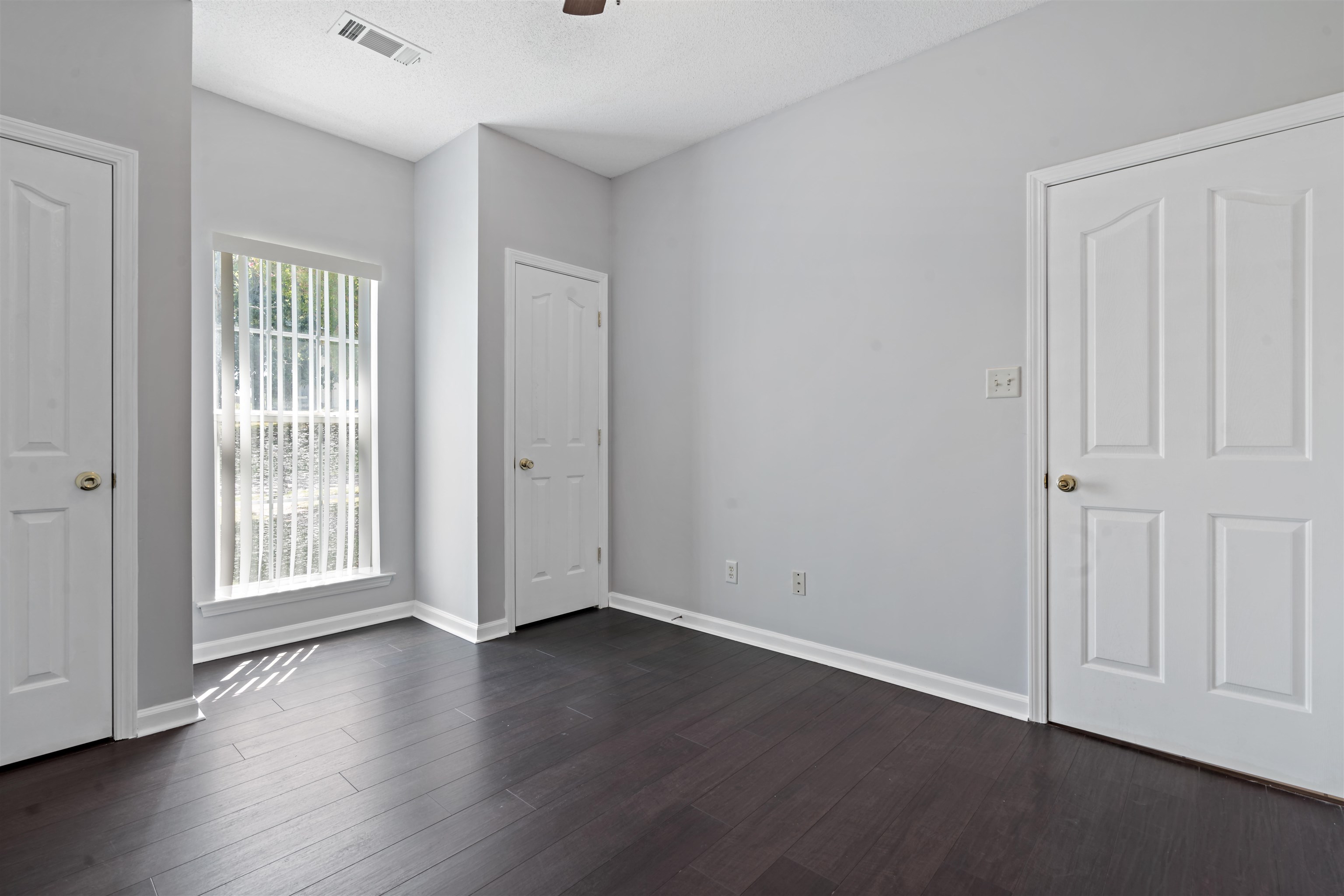 6814 Manslick Road Cordova, TN 38018 - Photo 15 of 20 Spare room featuring a textured ceiling and dark wood-type flooring