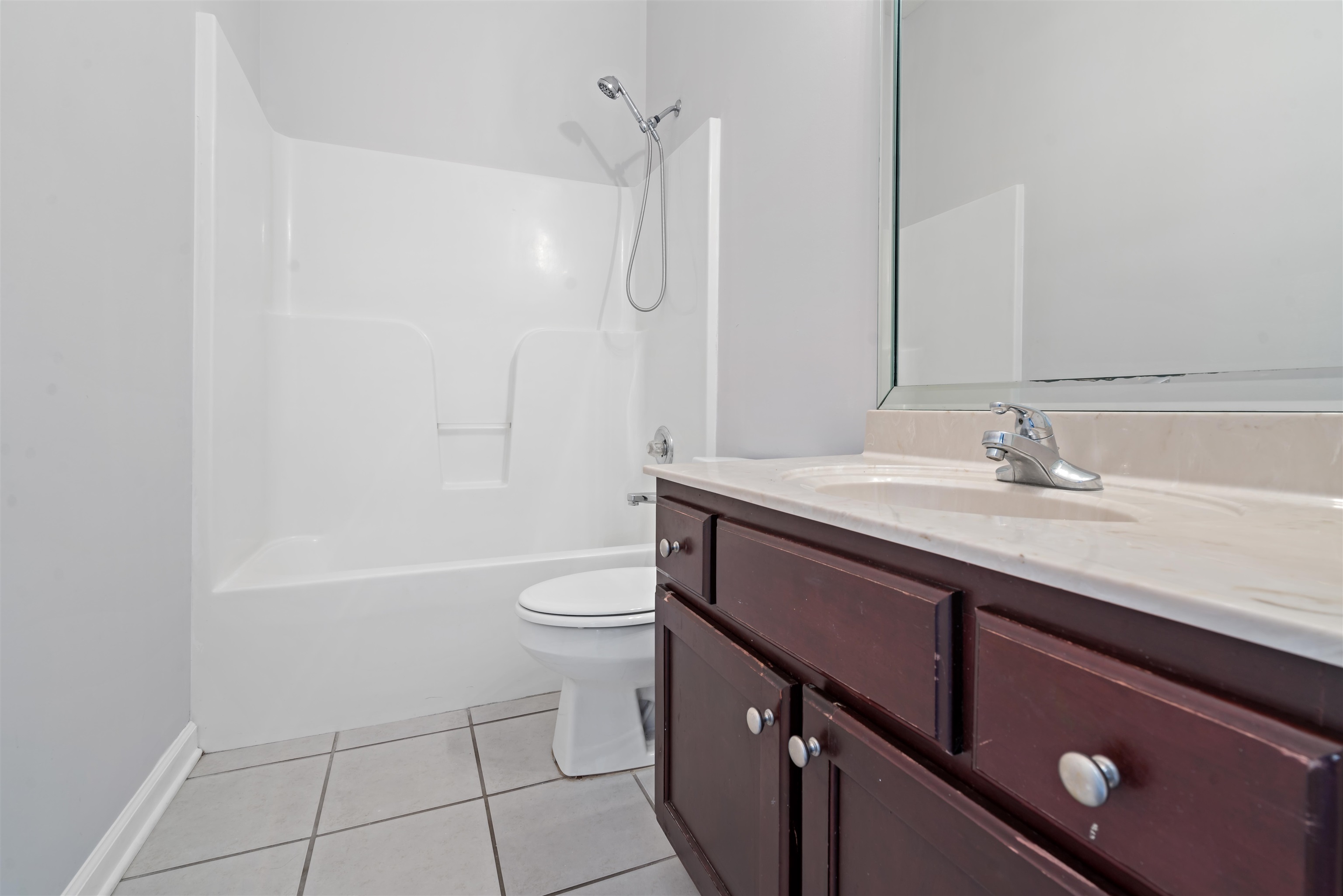 6814 Manslick Road Cordova, TN 38018 - Photo 17 of 20 Full bathroom featuring tile patterned flooring, bathing tub / shower combination, toilet, and vanity