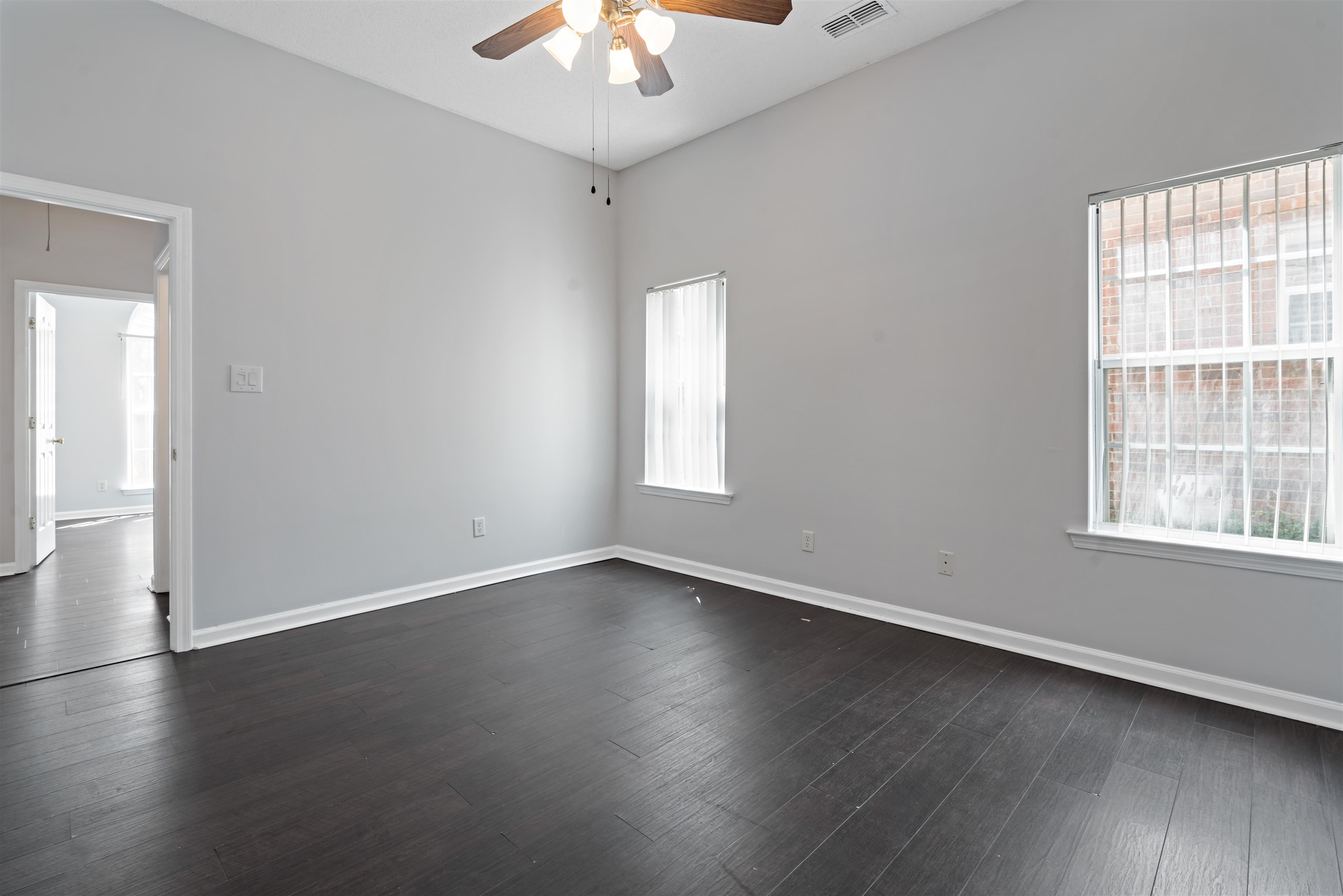 6814 Manslick Road Cordova, TN 38018 - Photo 9 of 20 Spare room with hardwood / wood-style floors, a towering ceiling, and ceiling fan