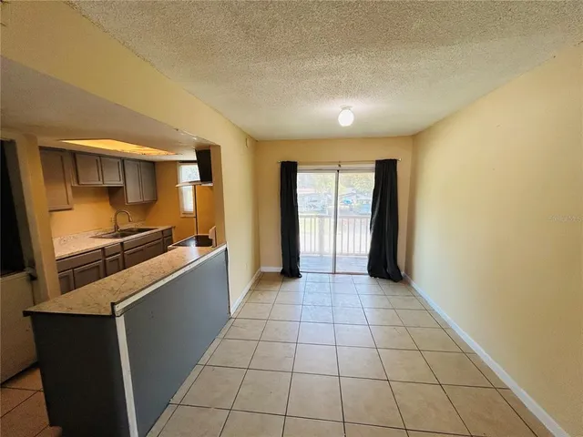 a kitchen with granite countertop a sink and a counter top space
