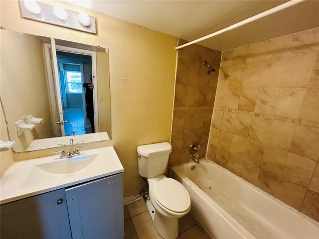 a bathroom with a sink mirror toilet and shower