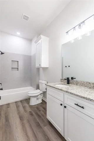 a view of a room with wooden floor and windows