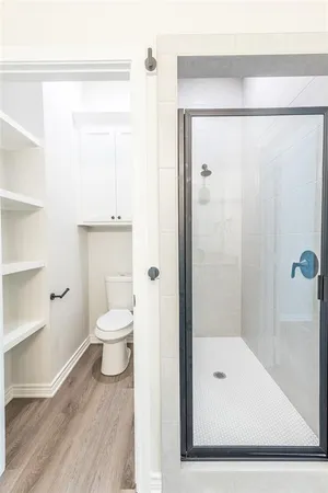 a view of walk in closet with empty racks