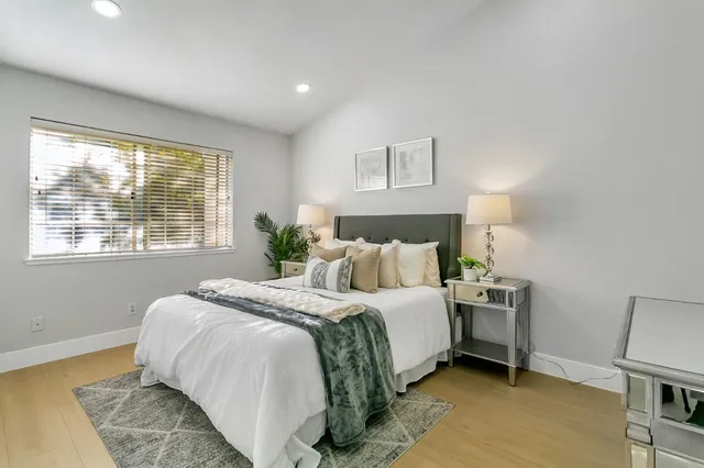 a bedroom with a bed and a window