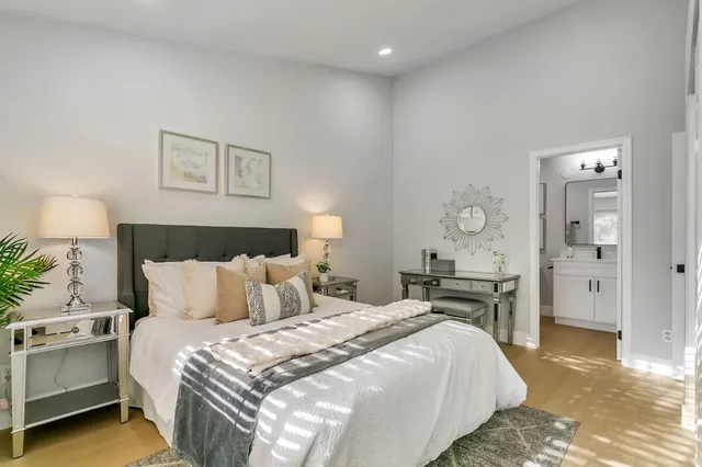 a bedroom with a bed and a chandelier