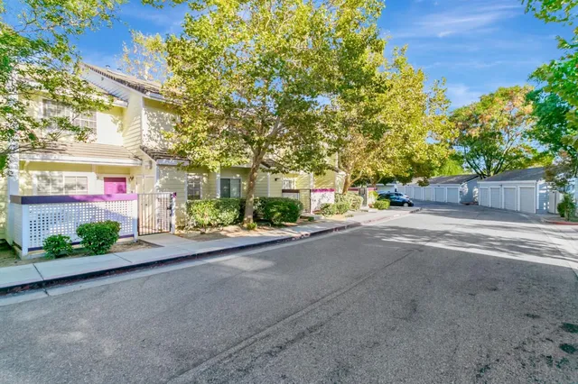 a couple of table and chairs sitting in yard with wooden fence