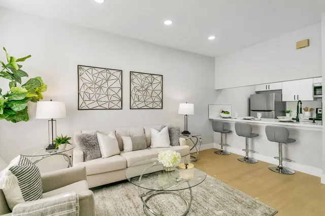a living room with furniture and white walls