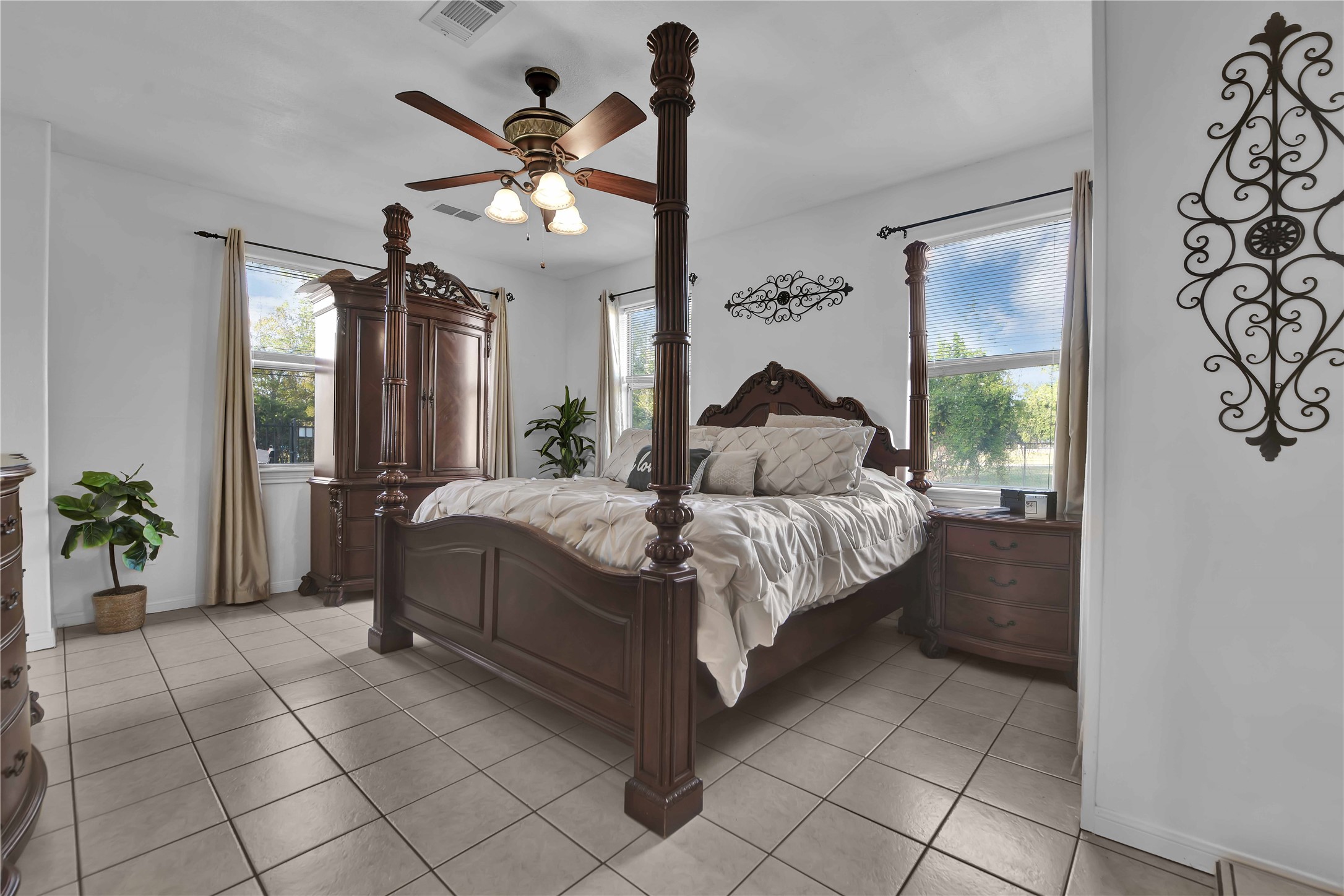 16326 Bear Bayou Drive Channelview, TX 77530 - Photo 19 of 50 a bedroom with a large bed and a chandelier