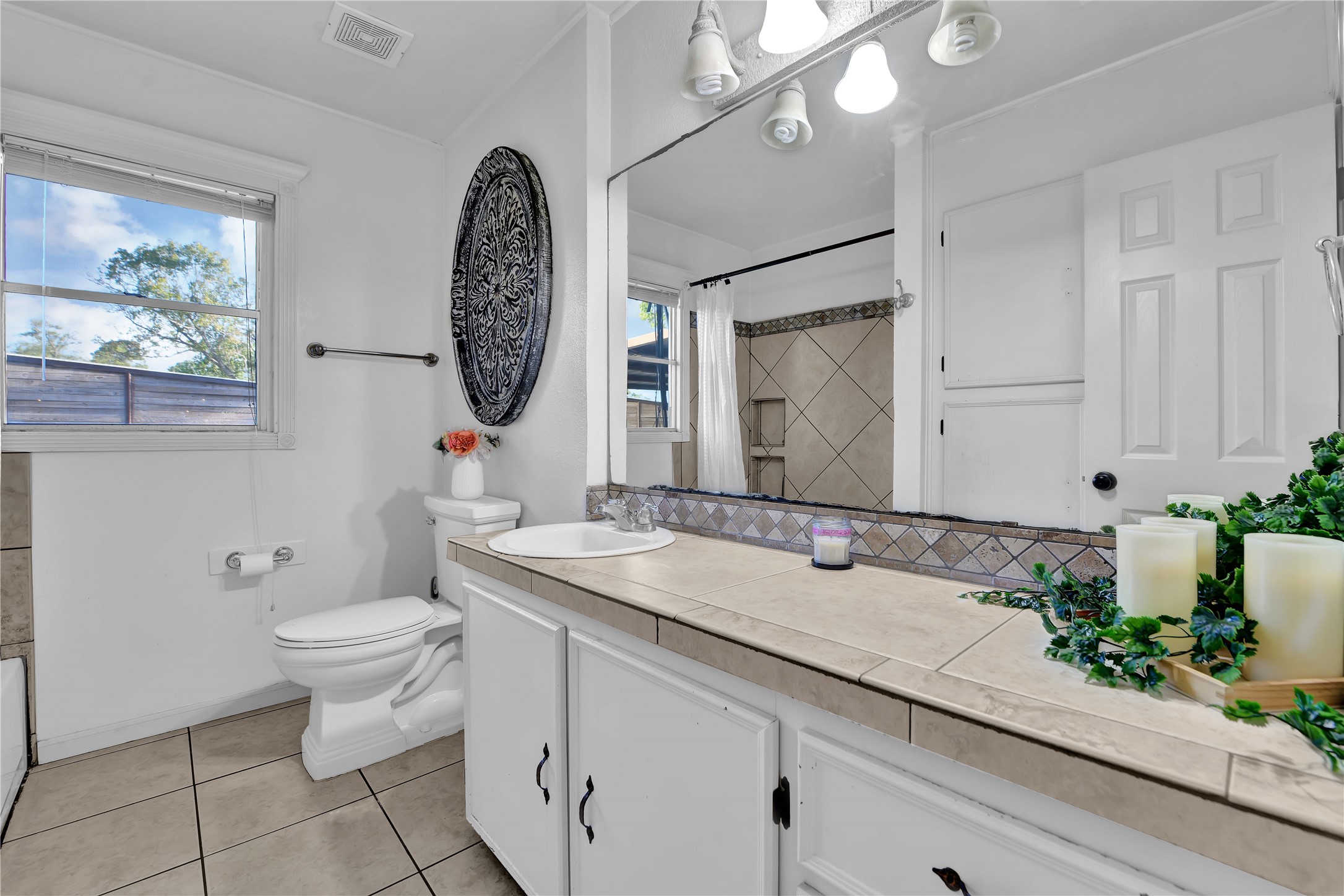 16326 Bear Bayou Drive Channelview, TX 77530 - Photo 22 of 50 a bathroom with a granite countertop sink mirror and toilet