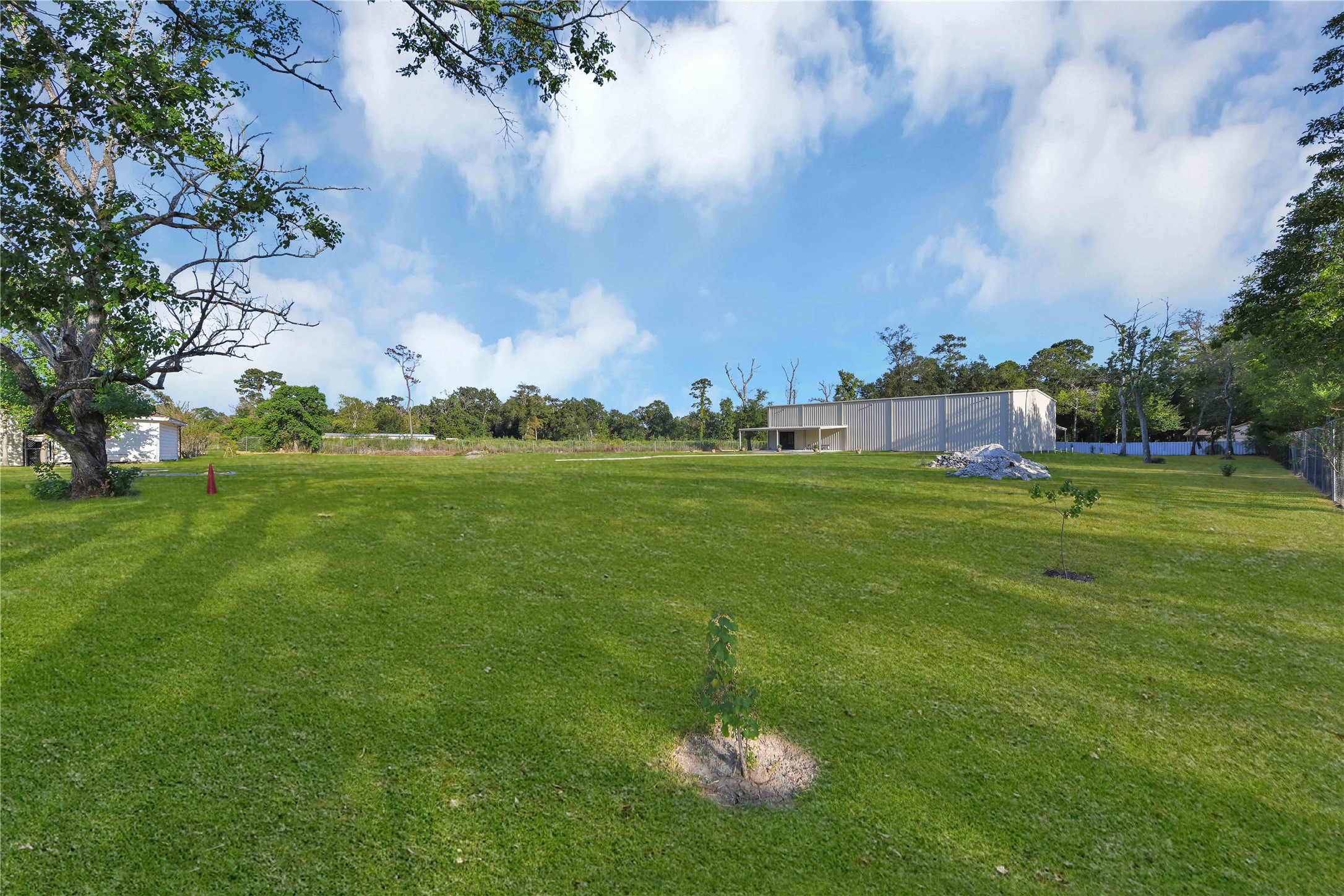 16326 Bear Bayou Drive Channelview, TX 77530 - Photo 49 of 50 a backyard of a house with lots of green space