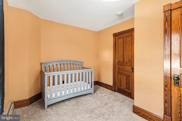 a view of a bedroom with wooden floor