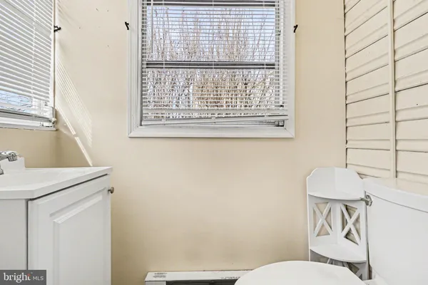 a white toilet sitting next to a bathroom sink