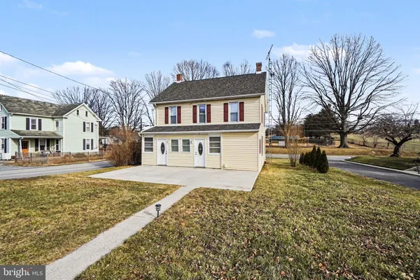 a front view of a house with a yard