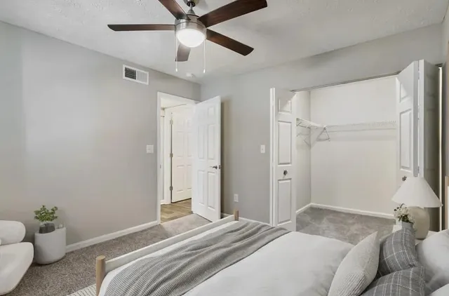 a bedroom with a bed and a couch