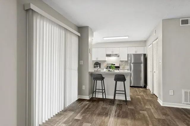 a kitchen with stainless steel appliances a refrigerator and a stove top oven
