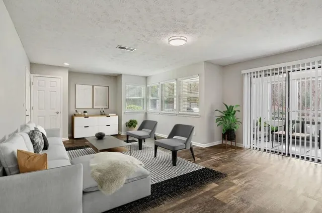 a living room with furniture and wooden floor