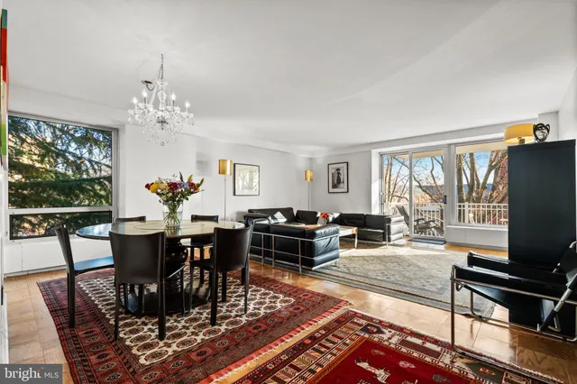 a view of a dining room with furniture and a chandelier
