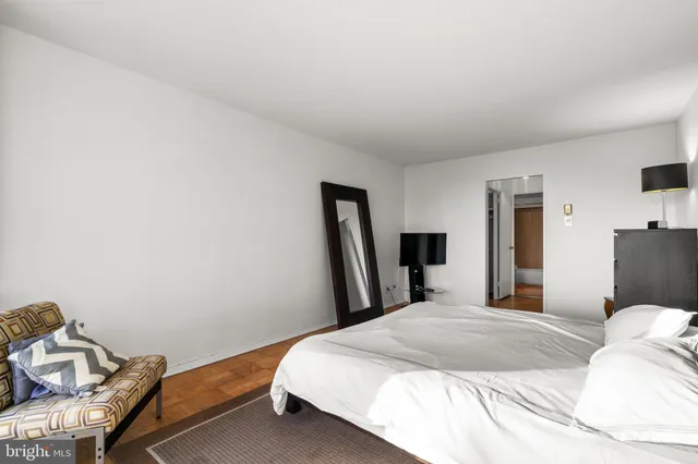 a bedroom with a bed and a night stand