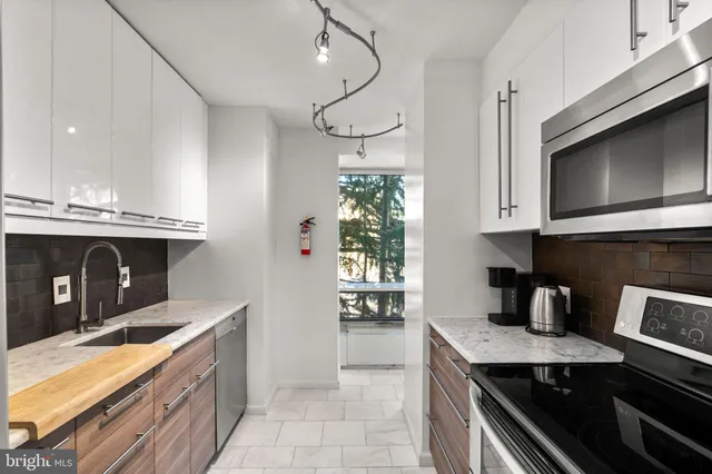 a kitchen with granite countertop a stove and a microwave