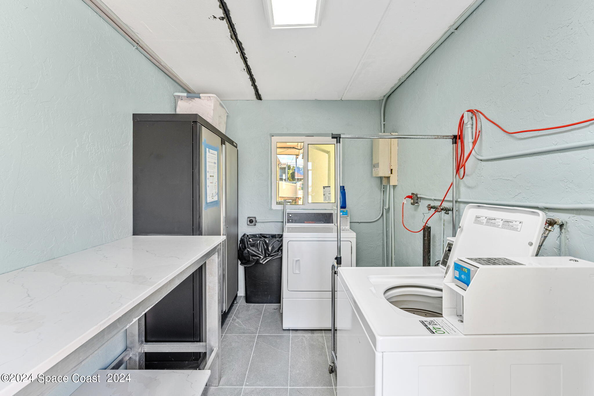 2189 Pineapple Avenue, Unit C Melbourne, FL 32935 - Photo 11 of 67 a kitchen that has a sink and a stove with white walls