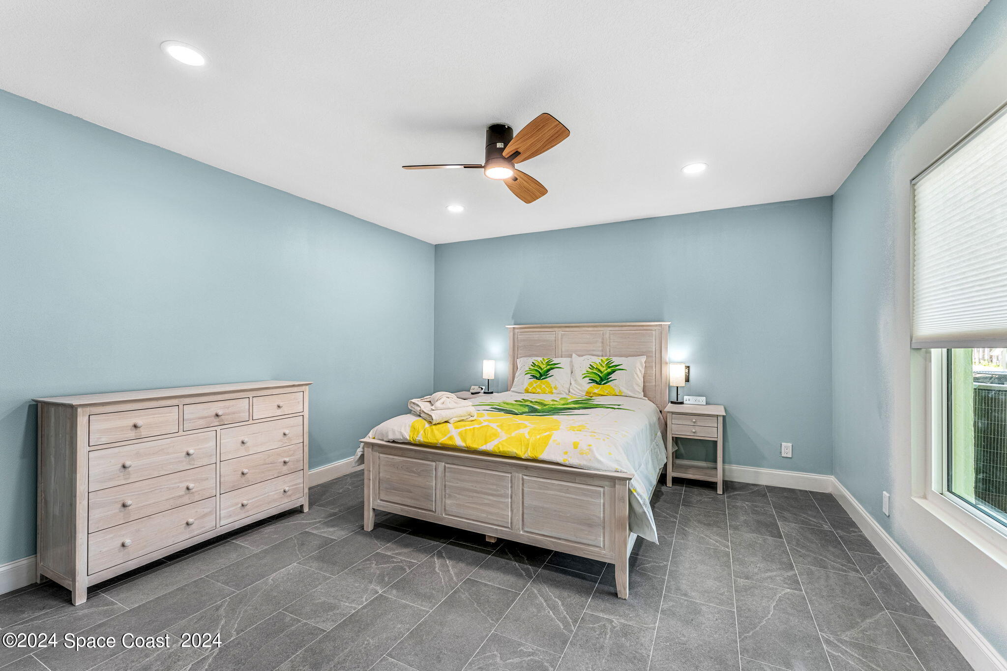 2189 Pineapple Avenue, Unit C Melbourne, FL 32935 - Photo 21 of 67 a bedroom with a bed and a window