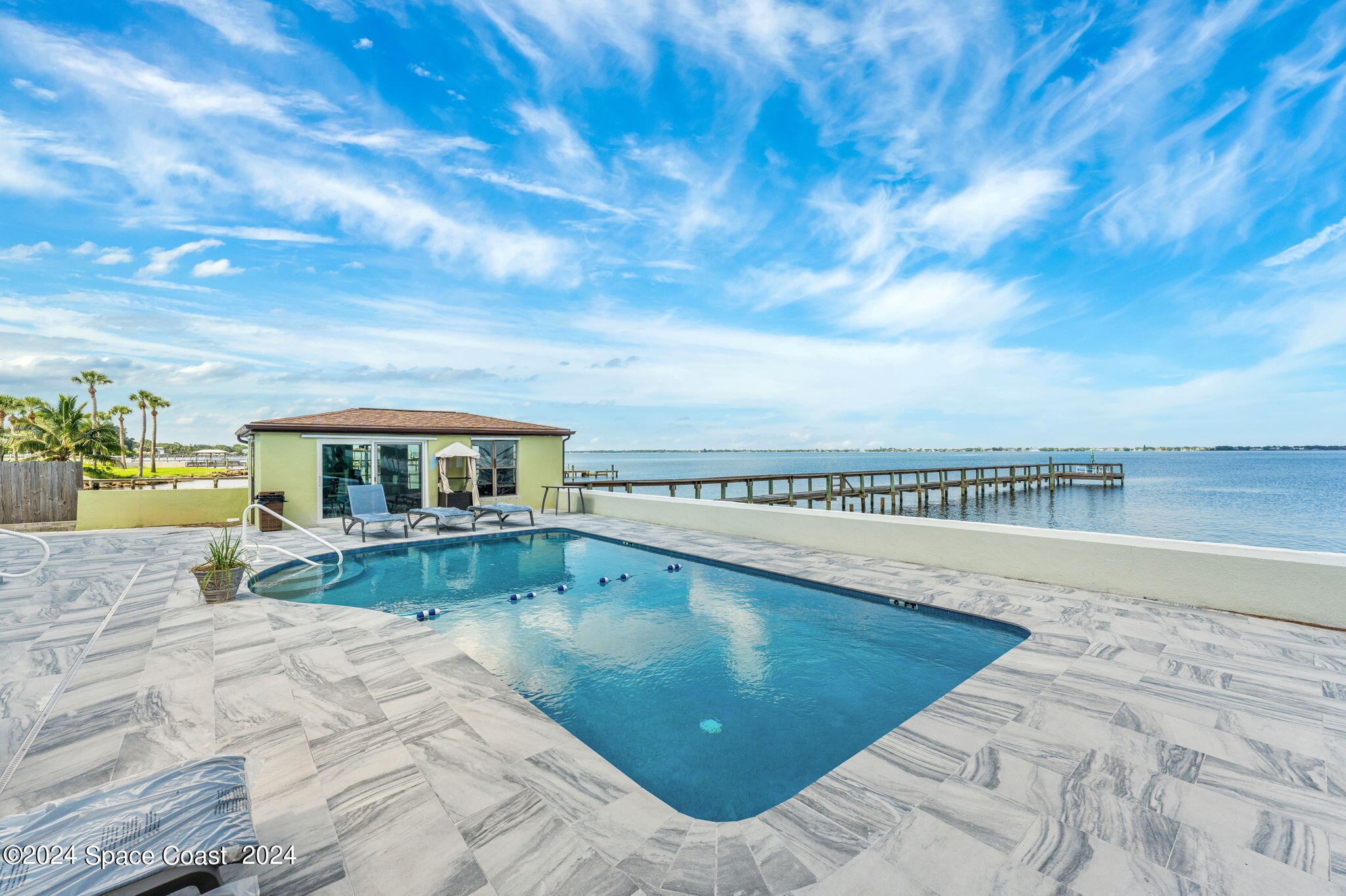 2189 Pineapple Avenue, Unit C Melbourne, FL 32935 - Photo 3 of 67 a view of a swimming pool with an outdoor seating