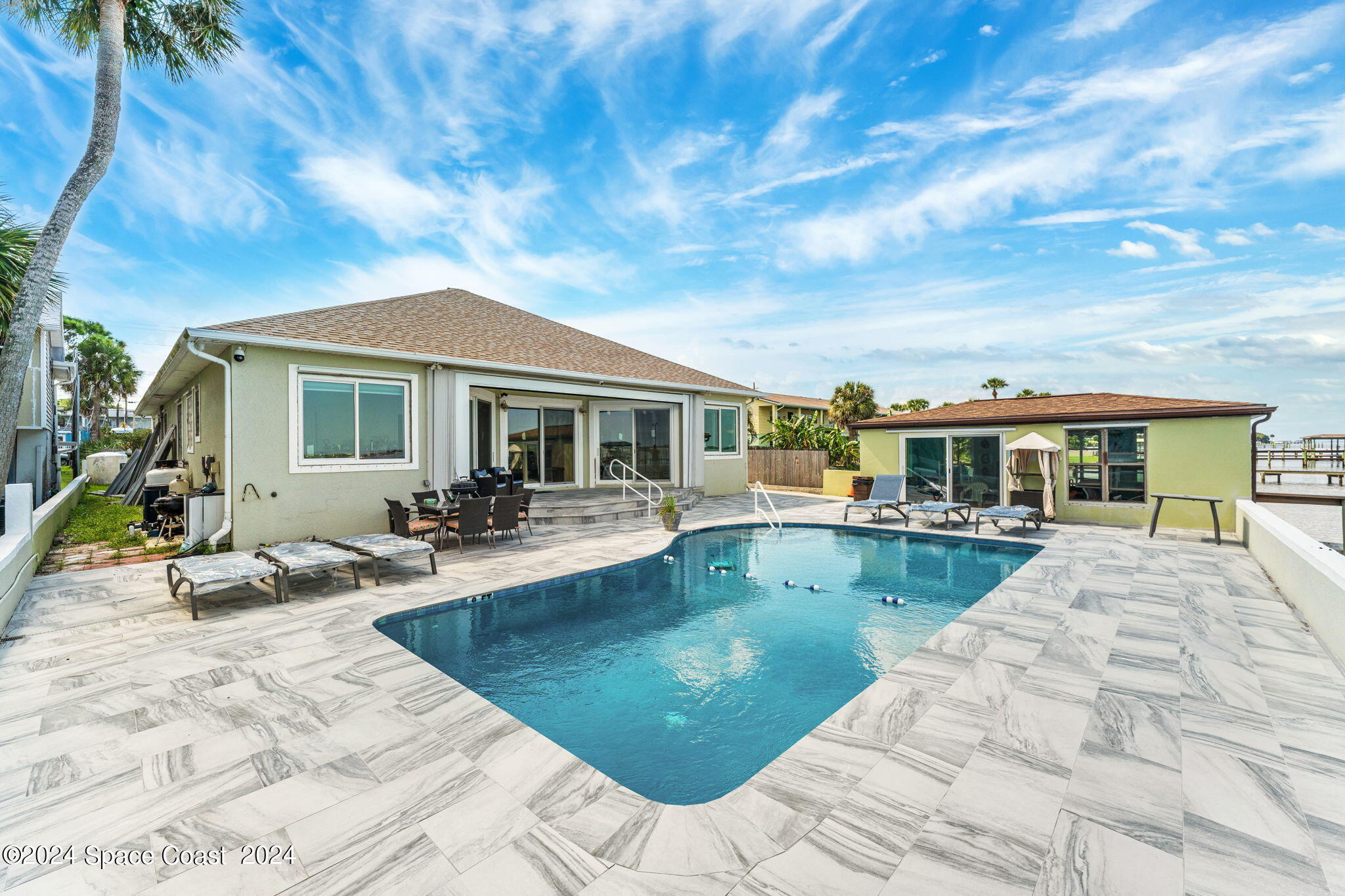 2189 Pineapple Avenue, Unit C Melbourne, FL 32935 - Photo 35 of 67 a view of a house with swimming pool and sitting area